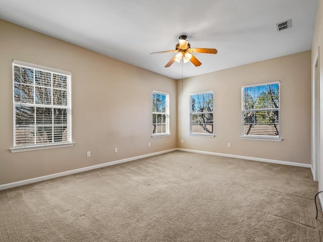 spare room featuring ceiling fan and carpet floors