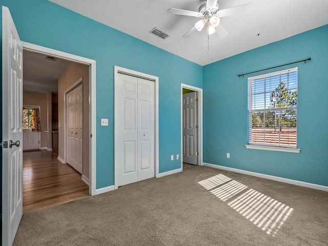 unfurnished bedroom with ceiling fan and carpet floors