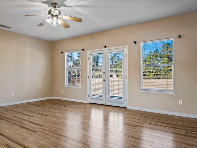 spare room featuring ceiling fan, light hardwood / wood-style flooring, and french doors