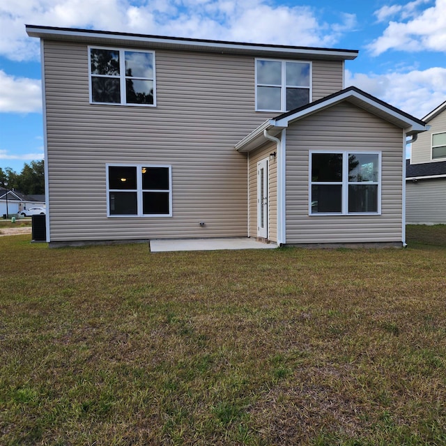 rear view of house with a patio area and a yard