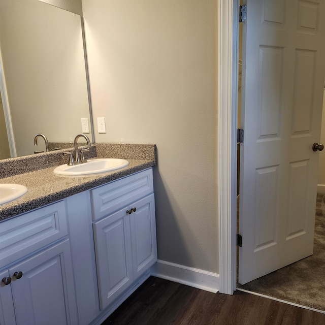 bathroom with wood-type flooring and vanity