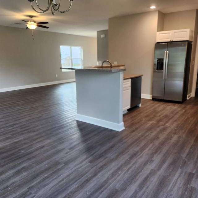 kitchen with stainless steel fridge, dark hardwood / wood-style floors, white cabinetry, and ceiling fan