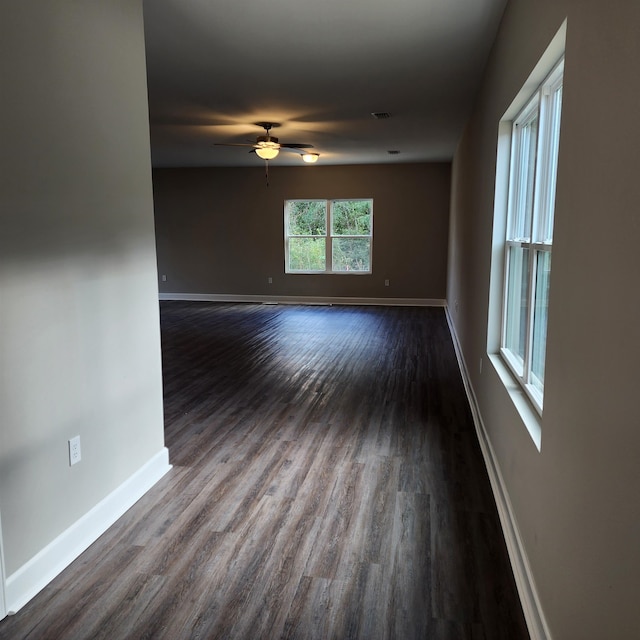 empty room featuring ceiling fan and dark wood-type flooring