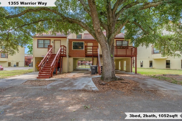 1355 Warrior Way Unit 67, Tallahassee, FL 32304 - multi unit property featuring a carport, stairs, and concrete driveway