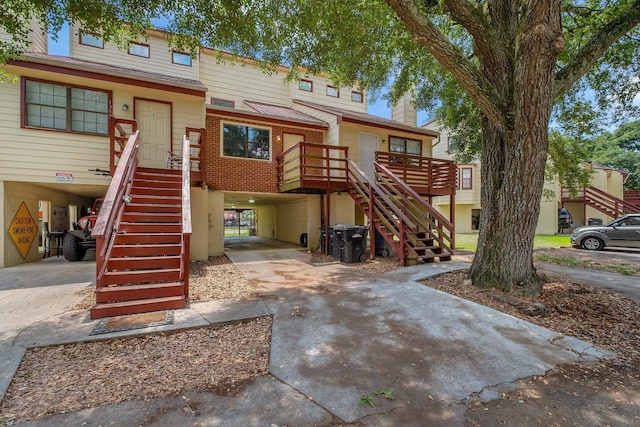 1355 Warrior Way Unit 67, Tallahassee, FL 32304 - view of front of property featuring stairway, a carport, and concrete driveway