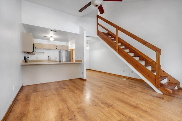 1355 Warrior Way Unit 67, Tallahassee, FL 32304 - unfurnished living room with a ceiling fan, a sink, high vaulted ceiling, stairs, and light wood-style floors