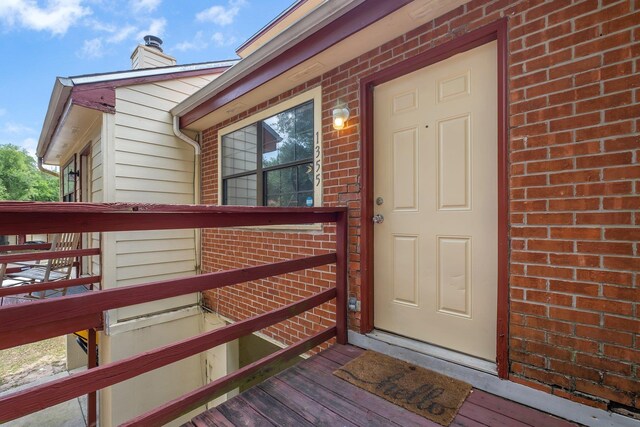 1355 Warrior Way Unit 67, Tallahassee, FL 32304 - property entrance featuring brick siding and a chimney