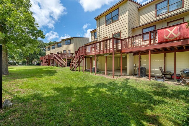 1355 Warrior Way Unit 67, Tallahassee, FL 32304 - rear view of house with central AC, a deck, stairs, and a lawn
