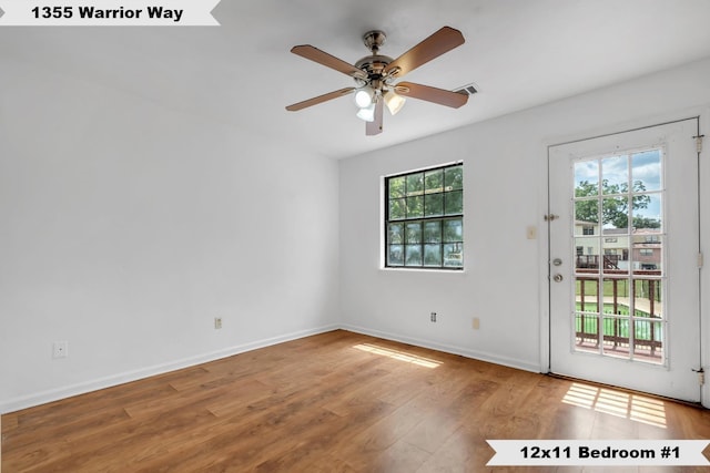1355 Warrior Way Unit 67, Tallahassee, FL 32304 - doorway featuring ceiling fan, wood finished floors, and baseboards