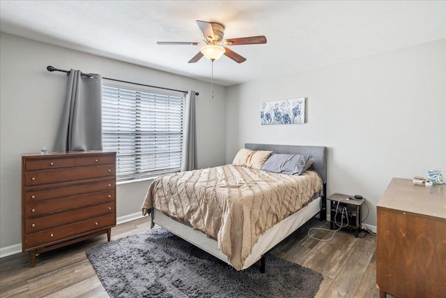 bedroom featuring dark hardwood / wood-style floors and ceiling fan