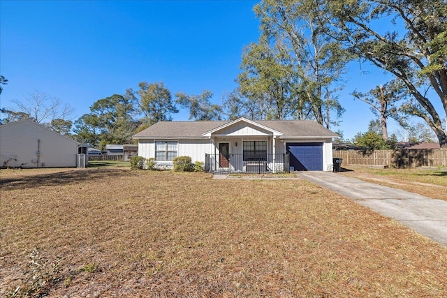 ranch-style home with covered porch, a garage, and a front lawn