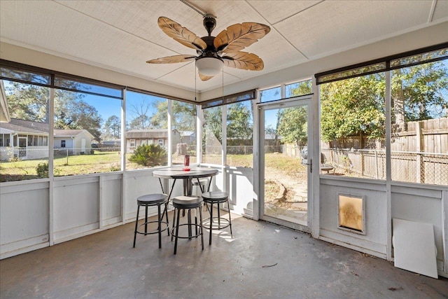 sunroom featuring a wealth of natural light and ceiling fan