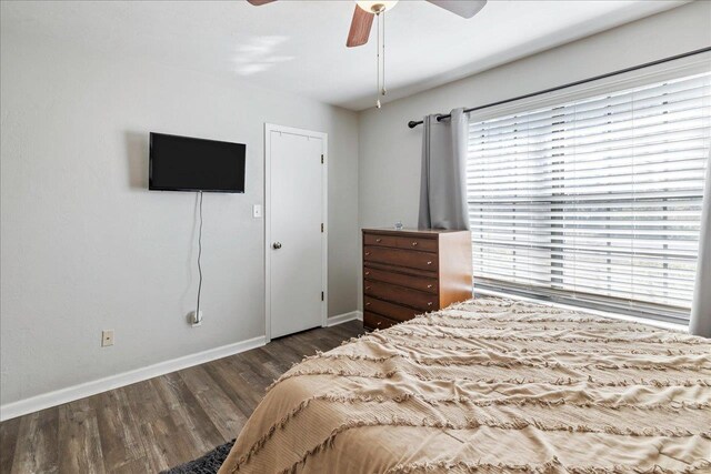 bedroom with ceiling fan and dark hardwood / wood-style floors