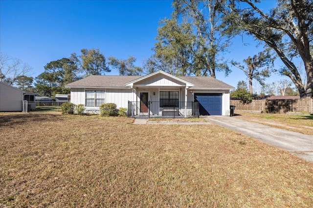 ranch-style home featuring a porch, a front yard, and a garage