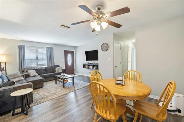 dining space with ceiling fan and hardwood / wood-style floors