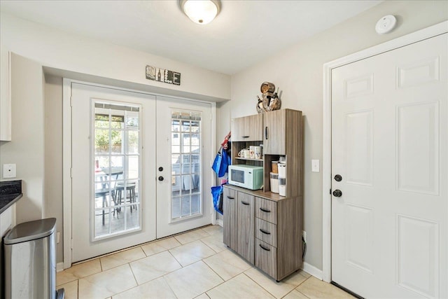 doorway to outside featuring french doors and light tile patterned floors