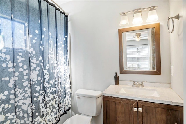 bathroom featuring vanity, ceiling fan, and toilet