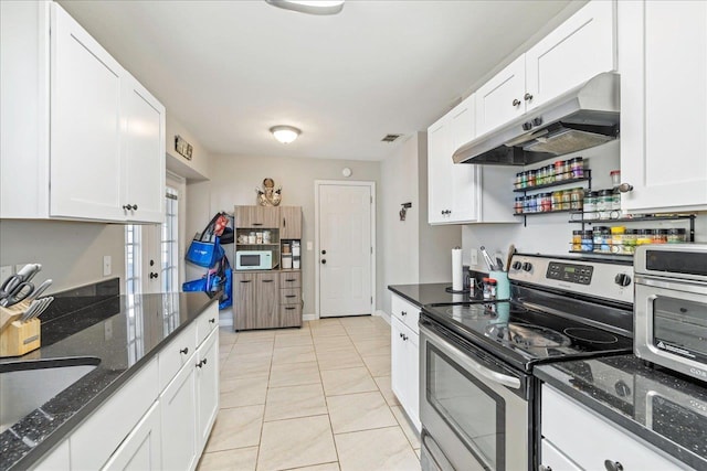 kitchen featuring electric range, white cabinetry, and light tile patterned floors