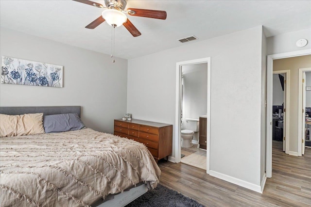 bedroom with ceiling fan, ensuite bathroom, and wood-type flooring