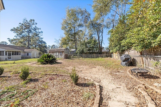 view of yard with a fire pit and a shed