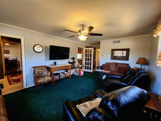 living room with crown molding, ceiling fan, and carpet