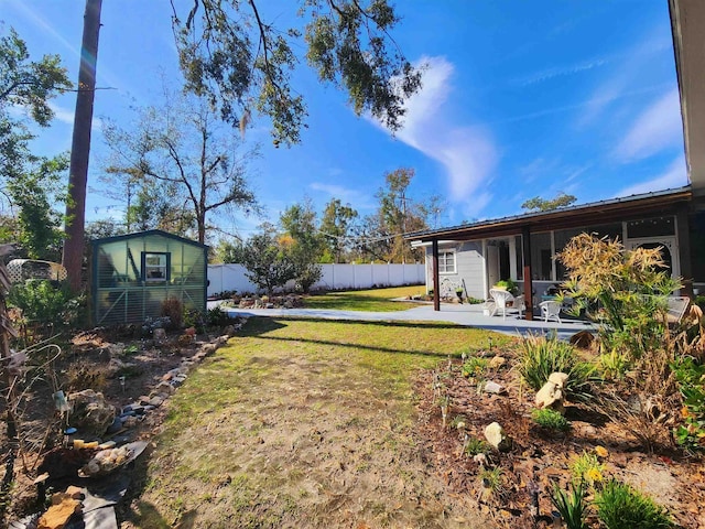 view of yard featuring a patio and a shed