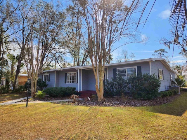 ranch-style house with central AC and a front yard