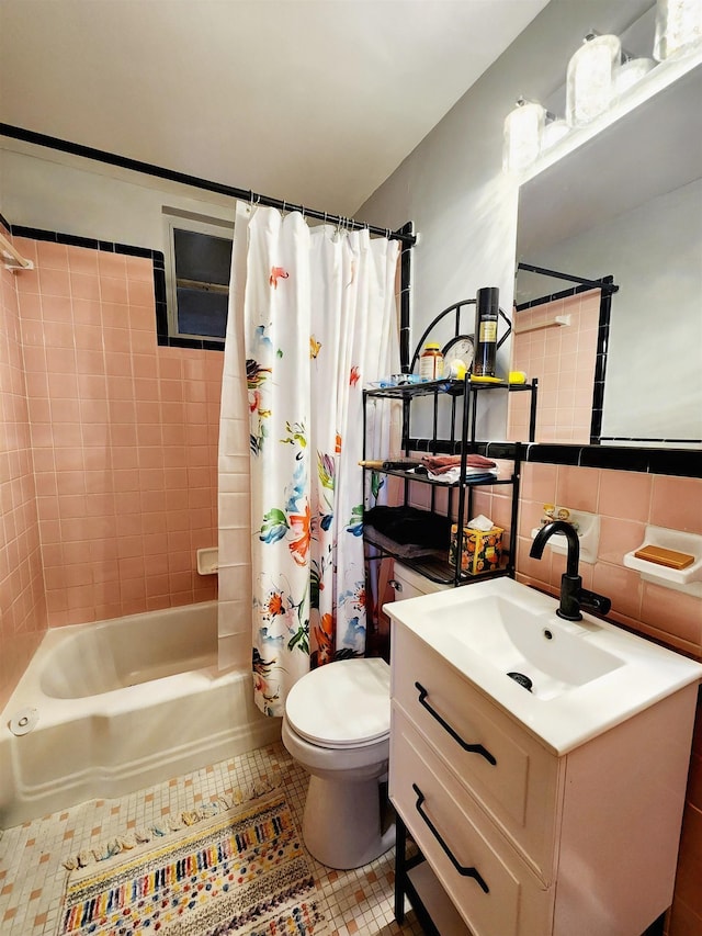 full bathroom featuring tile walls, shower / bath combination with curtain, tile patterned flooring, vanity, and toilet