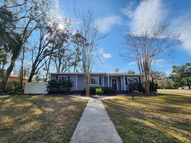 ranch-style home with a front yard