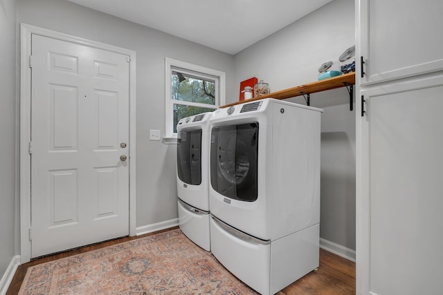 laundry area featuring laundry area, baseboards, wood finished floors, and independent washer and dryer