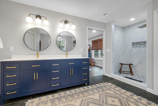 full bath with double vanity, visible vents, a walk in shower, and a sink