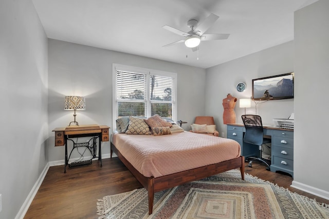 bedroom with dark wood-style flooring, ceiling fan, and baseboards