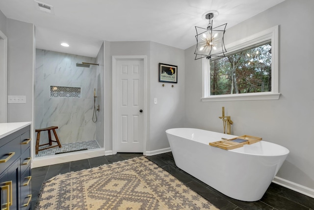 full bathroom with baseboards, a marble finish shower, visible vents, and a freestanding bath