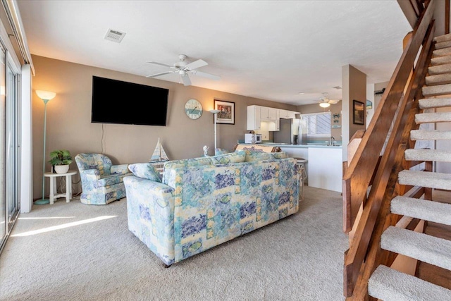 17 Harbour Point Dr, Crawfordville, FL 32327 - living room featuring a ceiling fan, light carpet, and stairway