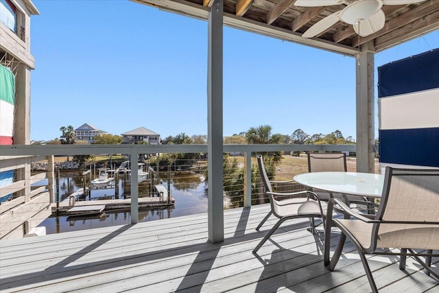 17 Harbour Point Dr, Crawfordville, FL 32327 - wooden deck with a ceiling fan, a water view, and a dock