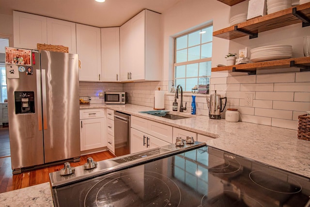 1682 Copperfield Cir, Tallahassee, FL 32312 - kitchen featuring appliances with stainless steel finishes, open shelves, white cabinetry, and light stone countertops