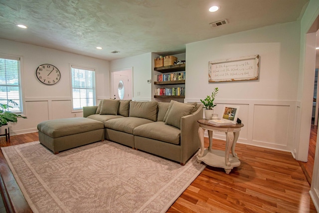 1682 Copperfield Cir, Tallahassee, FL 32312 - living area with a decorative wall, light wood finished floors, healthy amount of natural light, wainscoting, and recessed lighting