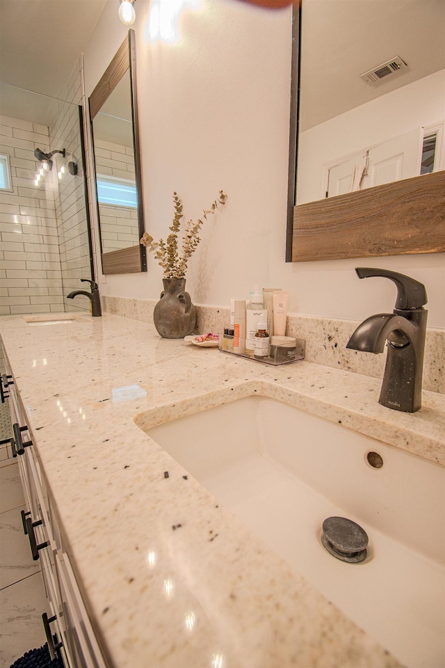 1682 Copperfield Cir, Tallahassee, FL 32312 - bathroom featuring double vanity and tiled shower