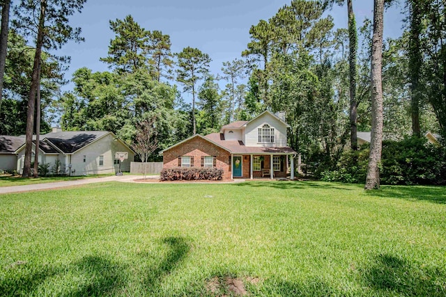 1682 Copperfield Cir, Tallahassee, FL 32312 - view of front facade featuring a chimney, covered porch, brick siding, and concrete driveway