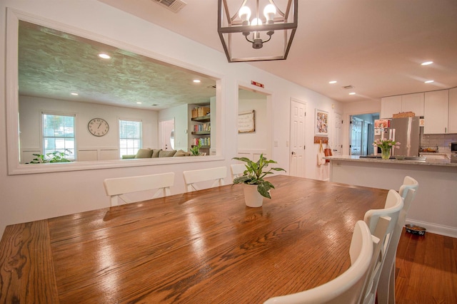 1682 Copperfield Cir, Tallahassee, FL 32312 - dining room featuring recessed lighting, a chandelier, and wood finished floors
