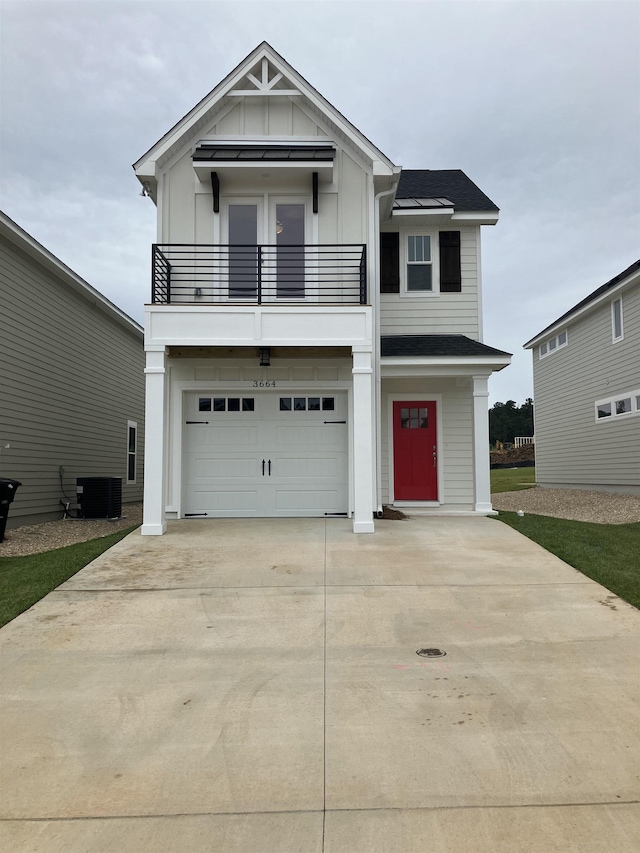 view of front of house featuring a balcony, cooling unit, and a garage