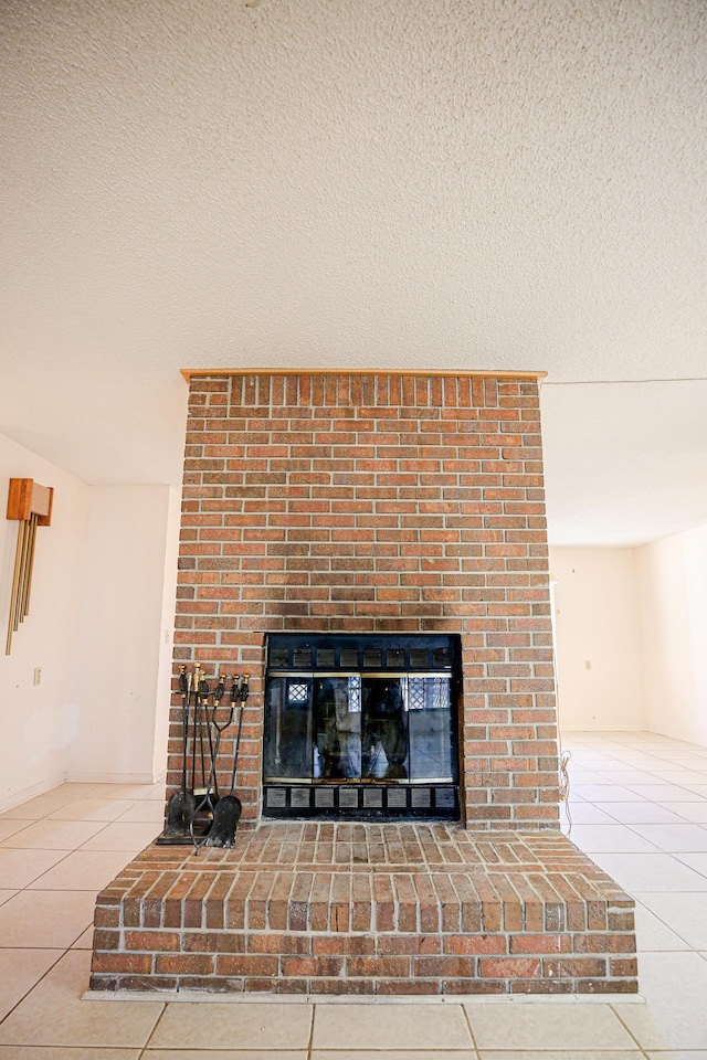 interior details featuring a textured ceiling and a fireplace