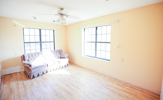 sitting room with a textured ceiling, ceiling fan, plenty of natural light, and light hardwood / wood-style flooring