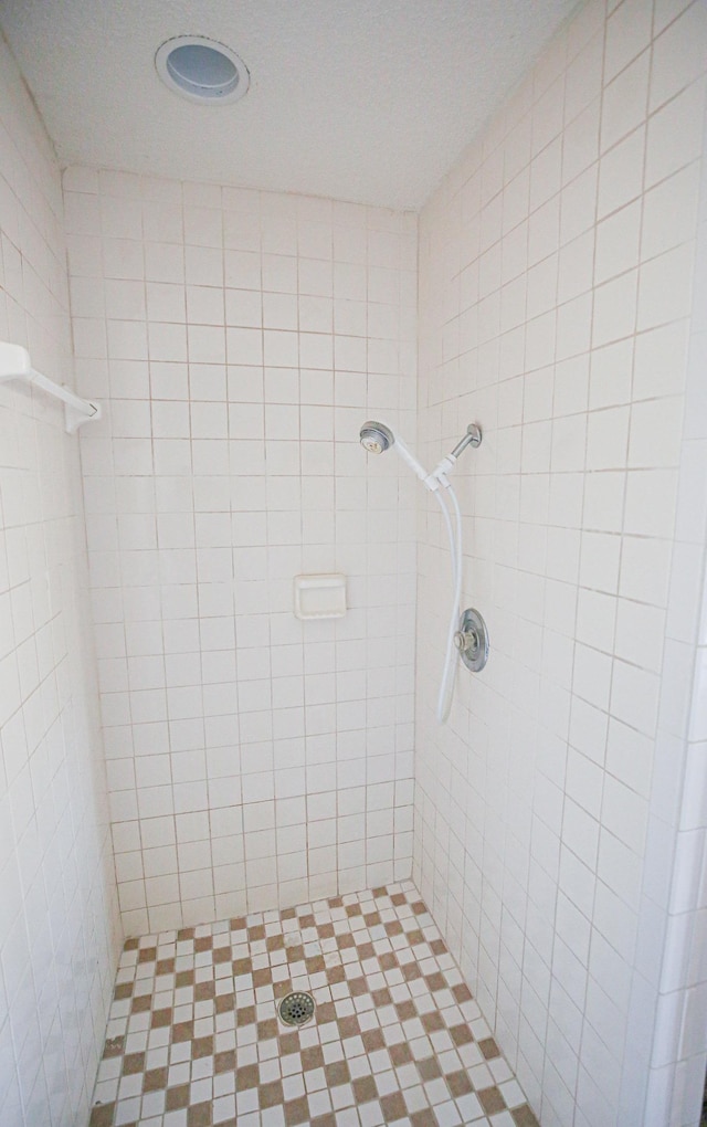 bathroom with a tile shower