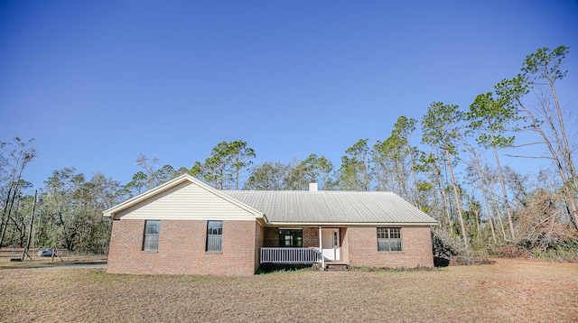 ranch-style house featuring a porch and a front lawn