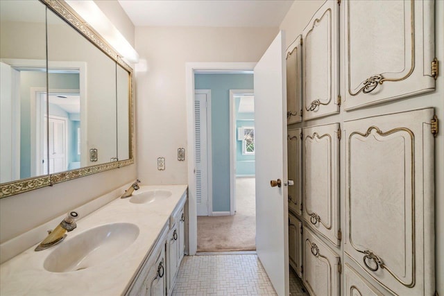 bathroom with a sink and double vanity