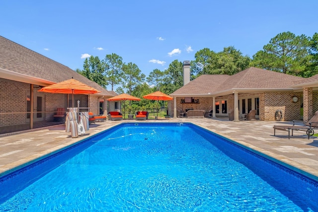 view of pool featuring an outdoor structure and a patio