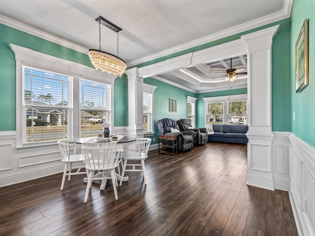 dining area featuring decorative columns, crown molding, a ceiling fan, and dark wood-style flooring