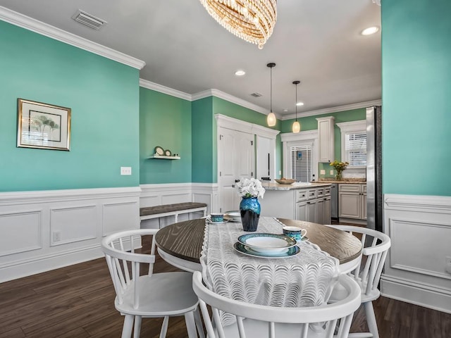 dining space with visible vents, a wainscoted wall, dark wood-style flooring, crown molding, and recessed lighting