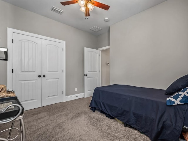 carpeted bedroom featuring baseboards, a closet, visible vents, and a ceiling fan